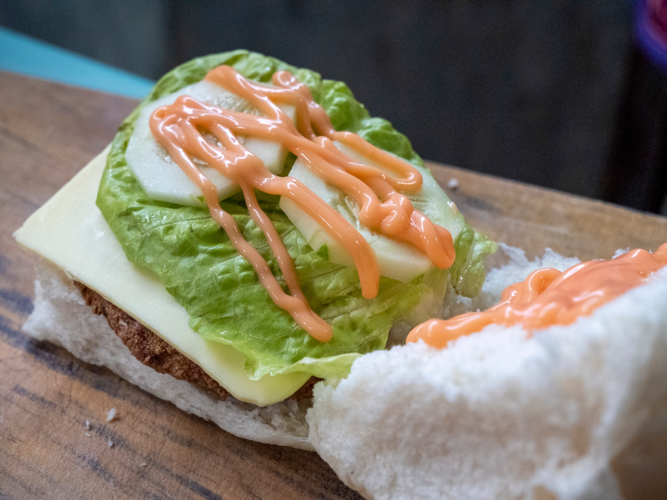 Presentation of the Tofu Burger with cheese, the most popular food item from the scholars’ vegetarian business.