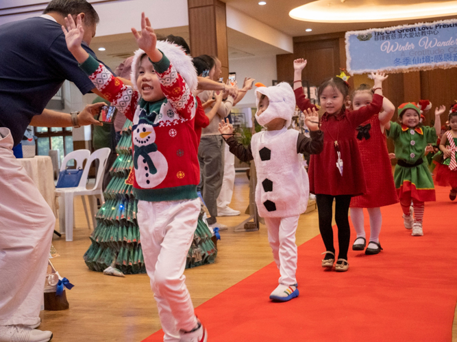 Students happily walk the red carpet, showing off their best costumes.