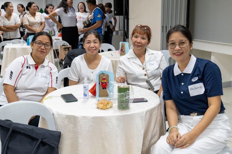 Melani Mapili (in blue and white) poses for a photo with fellow TechVoc scholar alumni during the homecoming event.