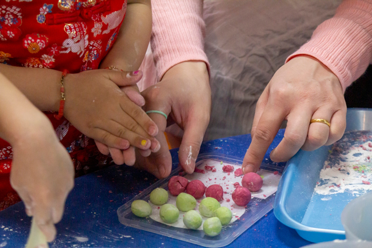 Creating glutinous rice balls (tang yuan) was an activity that encouraged a preschooler to participate and bond with his parents. The sticky balls are a symbol of prosperity and strong family ties. 