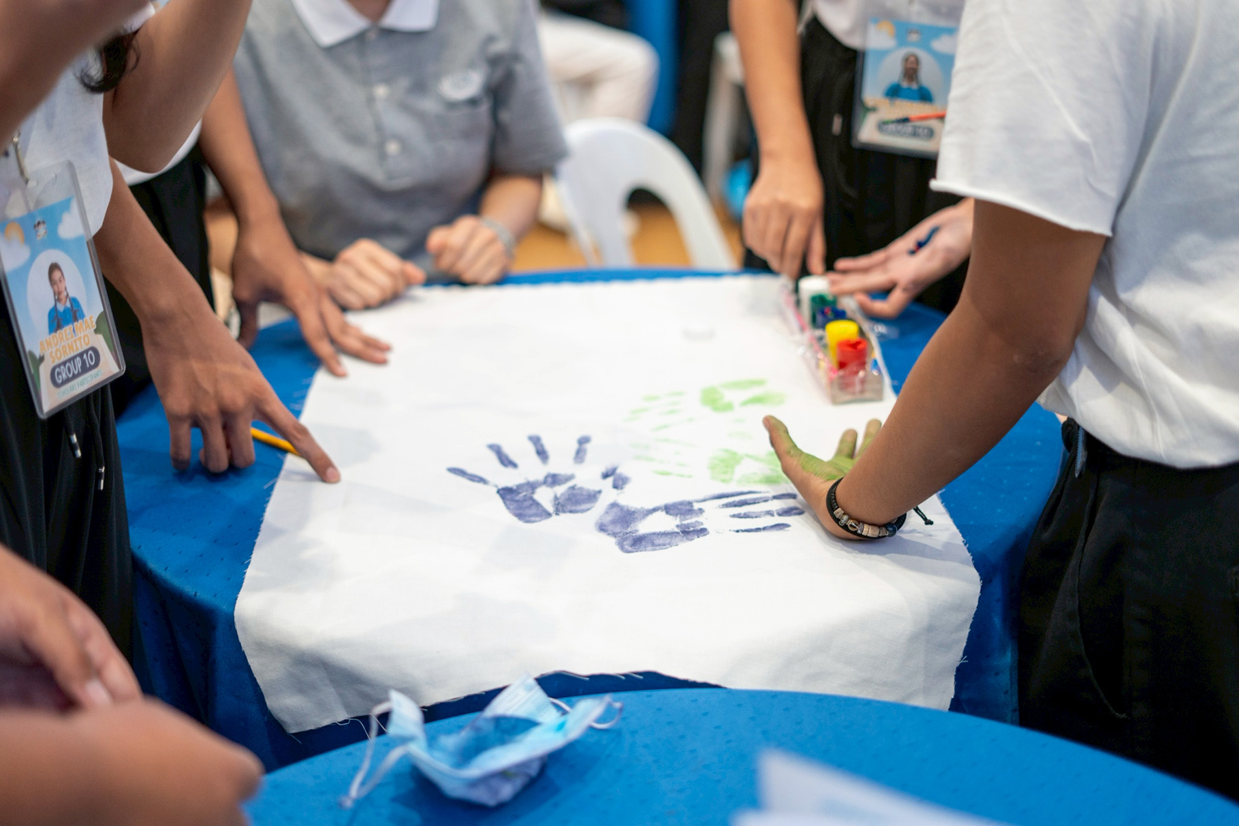 Scholars work together to create a distinct banner for their group. 