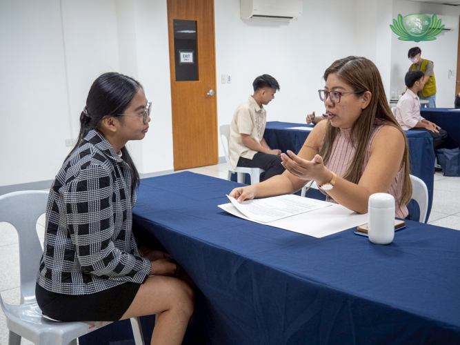 Tzu Chi scholar Maricar Ascarez (left) gives her best effort as a candidate during the mock interview. “I’m grateful because apart from my studies, [Tzu Chi] gives us this opportunity that not everyone gets,” she says.