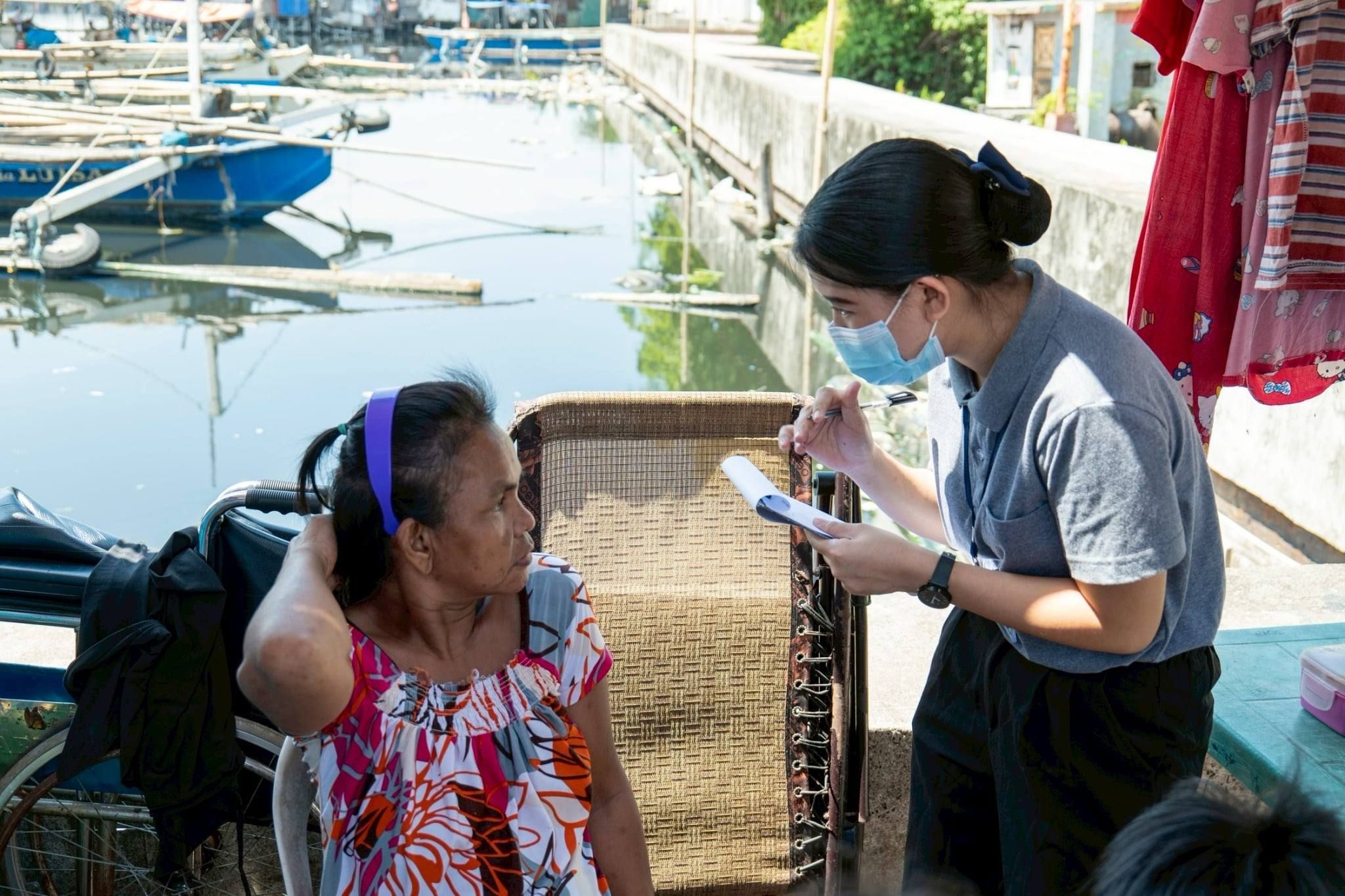 Now a Registered Social Worker and a Social Welfare Officer at Tzu Chi Foundation, Shekinah Salazar (right) extends compassion to the beneficiaries she meets. 