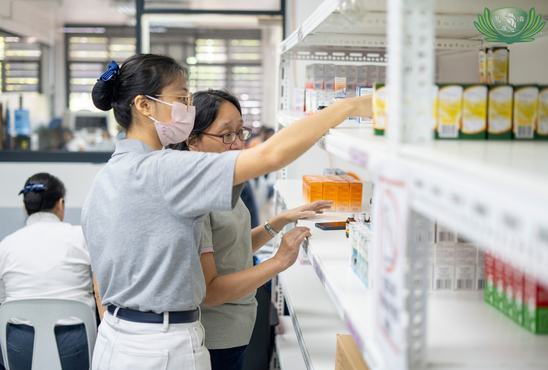 At the pharmacy, Tzu Chi volunteers help organize the inventory of medicines and vitamins.