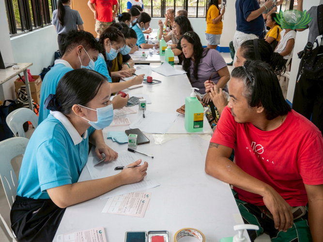 Tzu Chi scholars give their best efforts in processing and releasing relief stubs.
