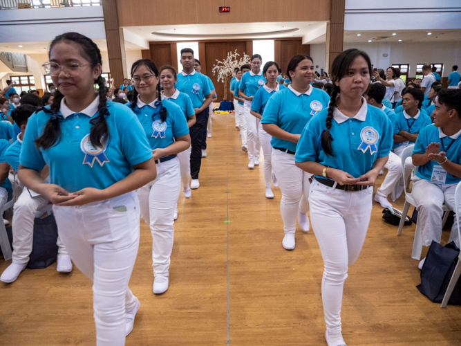 Graduating scholars enter the Jing Si Auditorium in disciplined fashion.