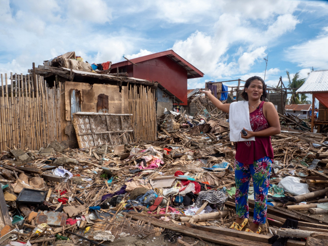 Maricris Japos from Barangay Ondol shows what she and her family came home to after spending the night in an evacuation center: personal belongings reduced to debris. 【Photo by Marella Saldonido】