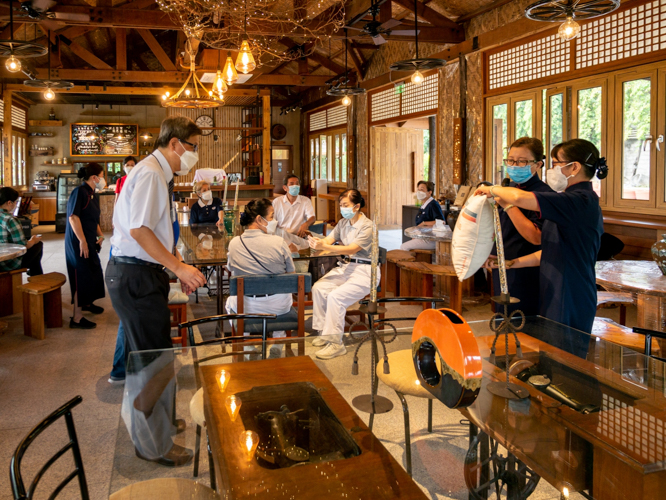 Guests relax at the Tzu Chi café, which serves vegetarian food in a structure made of recycled and upcycled materials. 【Photo by Daniel Lazar】