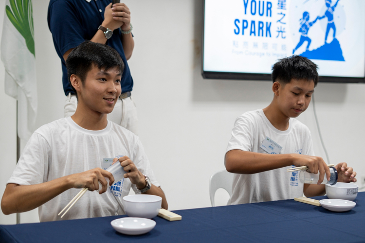 Participants try to earn points for their respective teams in a live demonstration of eating Tzu Chi style. 