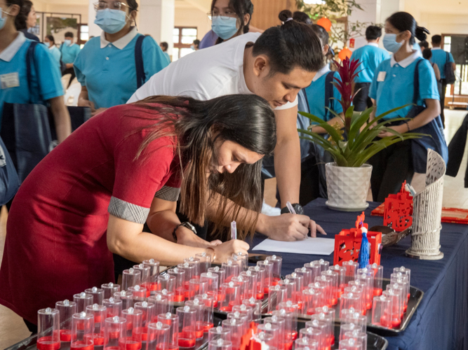 At the entrance of Jing Si Auditorium, guests and volunteers are invited to write down their wishes for the new year, encase them in battery-operated votive candles, and place them on a shelf.