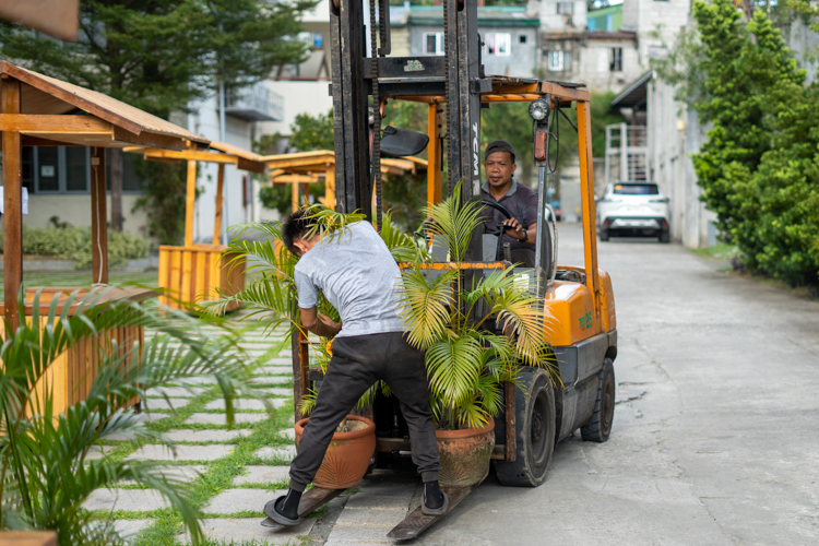 Charlie Centes, Tzu Chi’s all-around maintenance man, drives a forklift to move heavy potted plants and food carts to the plaza. 