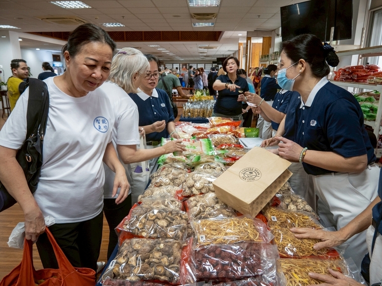 Customers go over a wide assortment of vegetarian ingredients at the Harmony Hall.