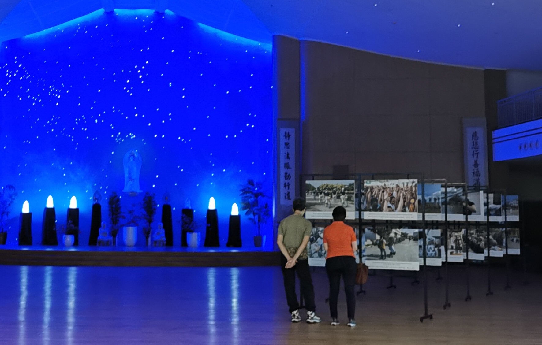 A couple looks at the photos of Tzu Chi activities on exhibit inside the Jing Si Hall.