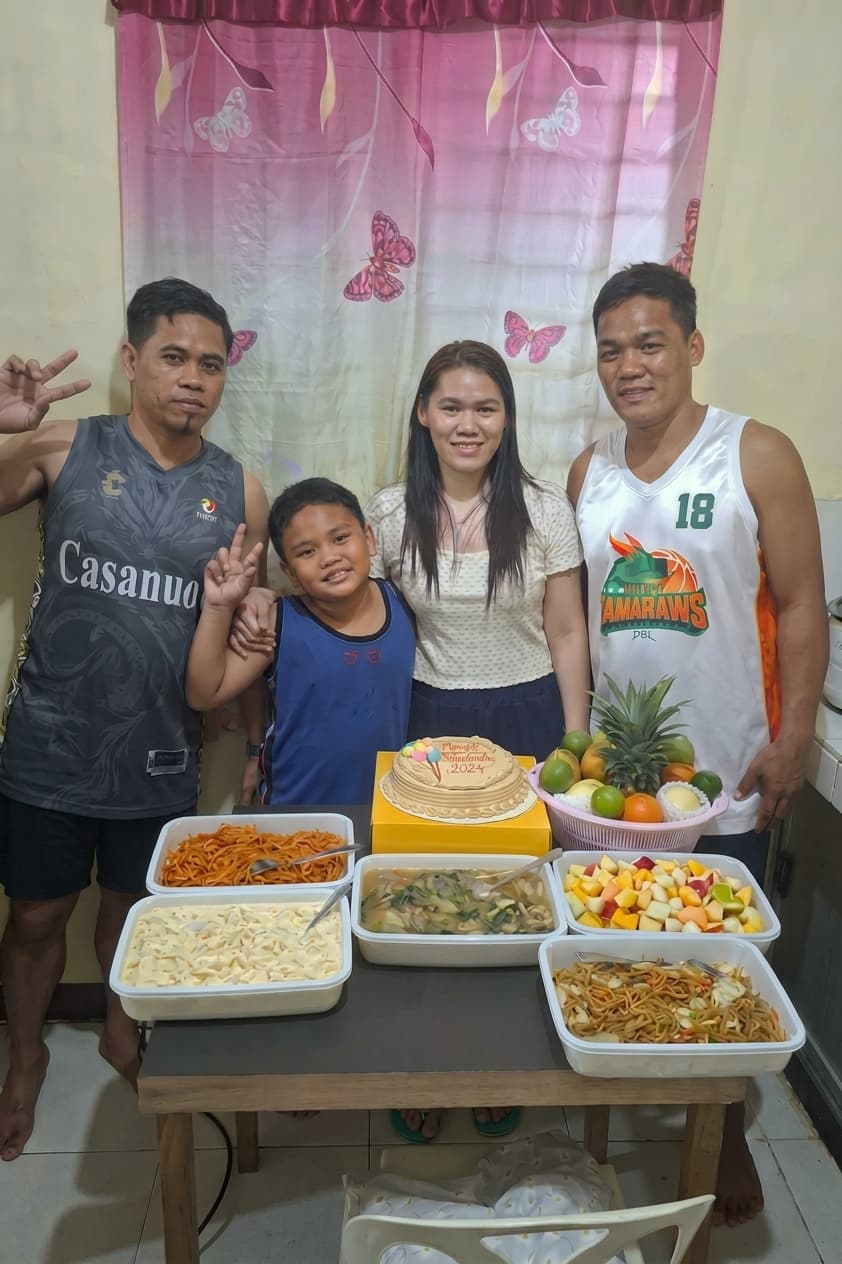 During her interview, Renancie Abiera (second from right) tearfully reflects on her brother (first from left), whose unwavering support and encouragement gave her the emotional strength to pursue her dreams.