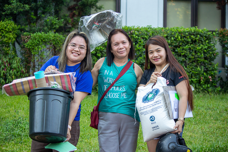 Beneficiary Vilma Escatron (center), her daughter, Gina Escatron (left) and another beneficiary pose with the items they received from Tzu Chi. 【Photo by Marella Saldonido】