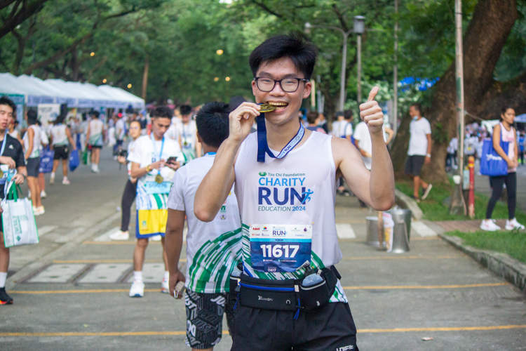 Runners proudly show off their finisher's medals.