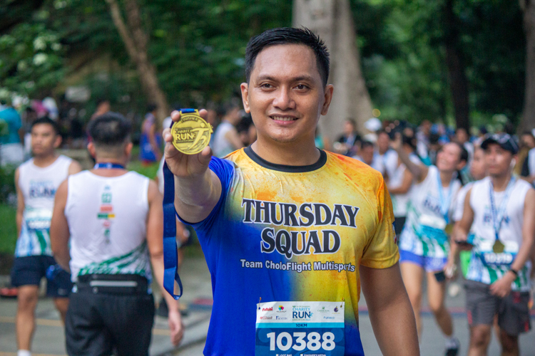 Runners proudly show off their finisher's medals.