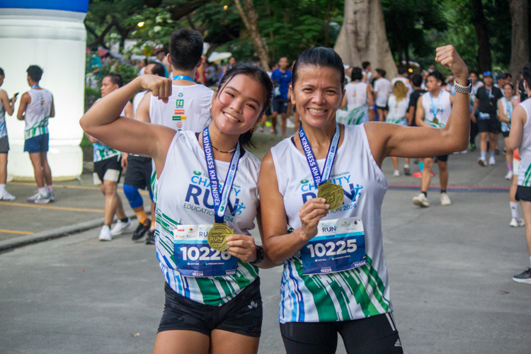 Runners proudly show off their finisher's medals.