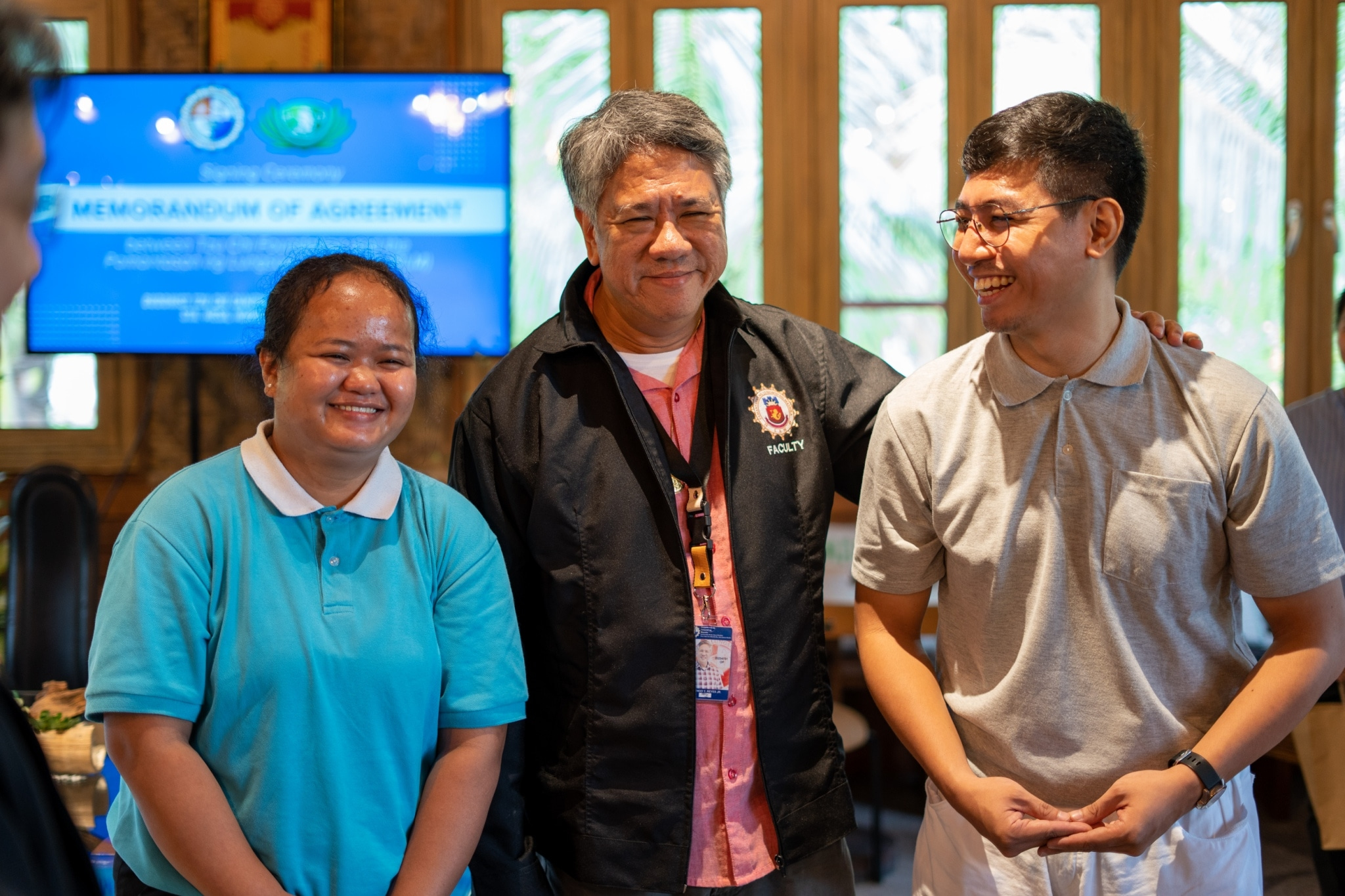 Partnerships for the future. Alumnus Jamil Carvajal (right) together with fellow Tzu Chi scholar Christine Cabuello shares a beautiful reunion with Atty. Domingo Reyes (center), President of the Pamantasan ng Lungsod ng Maynila (PLM) during the signing of a Memorandum of Agreement expanding the scholarship assistance of Tzu Chi Foundation for underprivileged PLM students.