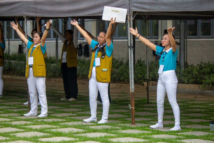 Volunteer scholars from different committees join in on the exercise dance.