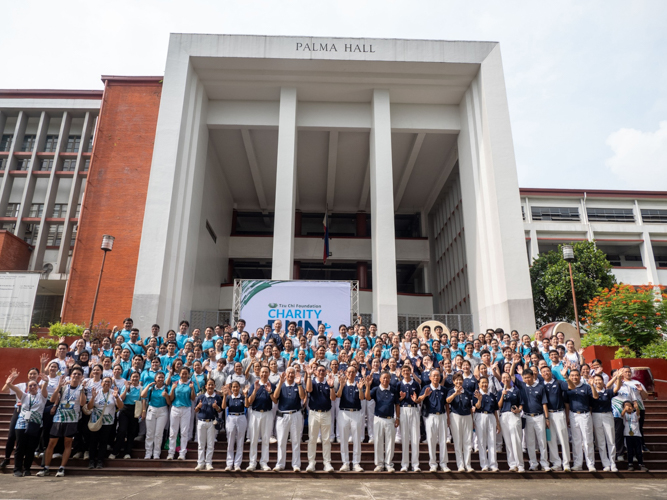 Tzu Chi volunteers and scholars gather for a group photo outside the University of the Philippines' Palma Hall following the successful staging of their first Charity Run for Education.