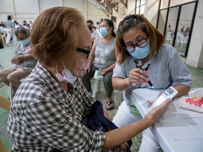 An ophthalmology patient gets her eyes assessed for free eyeglasses.