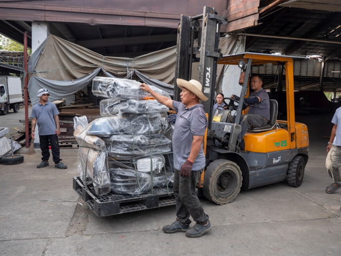 In the Buddhist Tzu Chi Campus in Sta. Mesa, Manila, staff members prepare the equipment for transport.