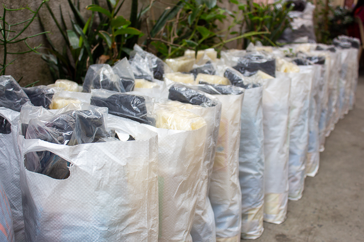 Bags of groceries, toiletries, and clothing were lined up and ready to be distributed.  【Photo by Marella Saldonido】