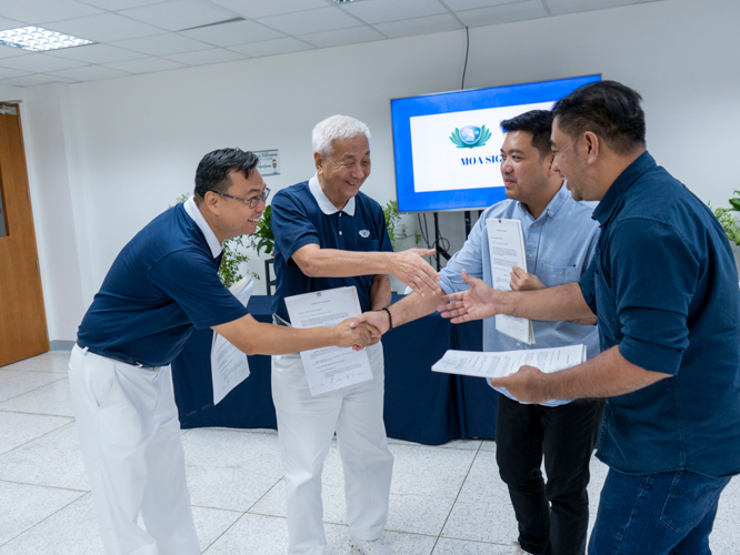 Tzu Chi Philippines and GetKlean Executives happily shake hands after the signing of the Memorandum of Agreement.
