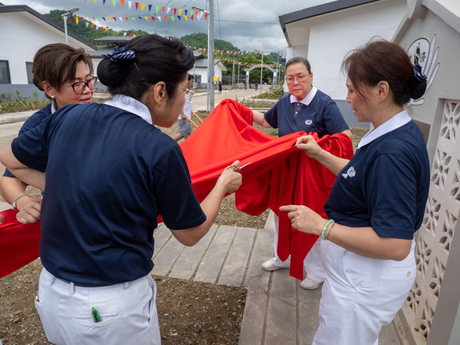 A red cloth is placed over the plaque at the Great Love Multi-Function Hall.