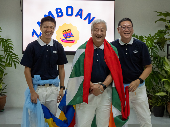 Waving flags, volunteers from Metro Manila, Bicol, Bohol Cebu, Davao, Palo, Pampanga, and Zamboanga make a lively entrance before the start of the planning session of the Tzu Chi 2023 Annual Meeting. 【Photo by Marella Saldonido】