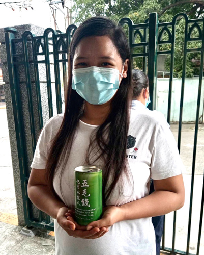 At the Buddhist Tzu Chi Campus in Sta. Mesa, Manila, Micholle Manila turns over a coin bank filled with pledges. ““It feels good to give, especially when you don’t expect anything in return,” she says. “That’s what I always tell my husband: to just keep giving, to keep helping.”