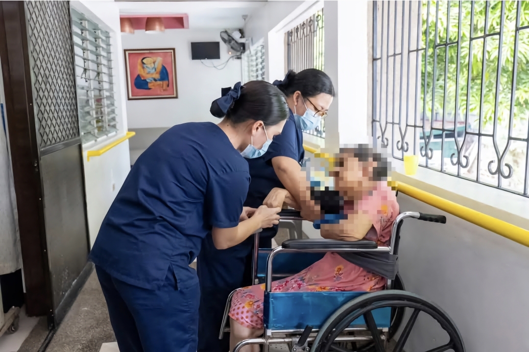 James Llenos’ fellow caregiving scholars take on responsibilities in the caregiving facilities, such as checking the patients’ vital signs.