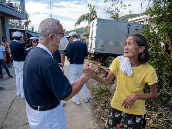 A volunteer gives hope and encouragement to a storm survivor. 【Photo by Harold Alzaga】