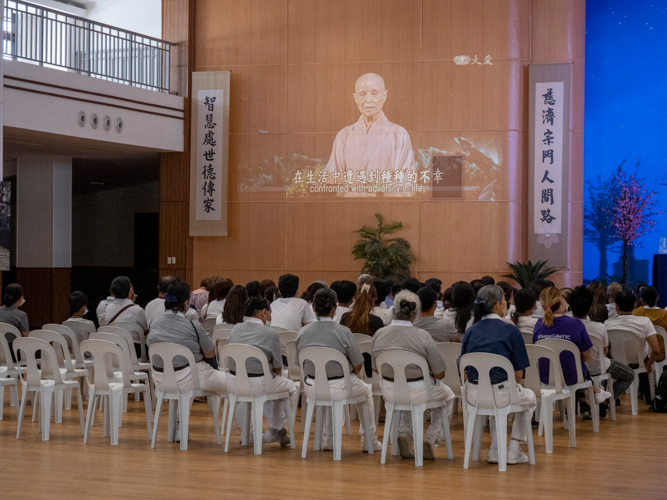 Beneficiaries watch a lecture of Dharma Master Cheng Yen at the Jing Si Auditorium. 【Photo by Matt Serrano】