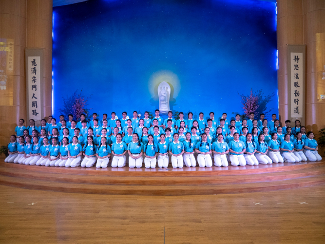 One hundred thirty graduating scholars pose for a group shot at the Jing Si Auditorium.  