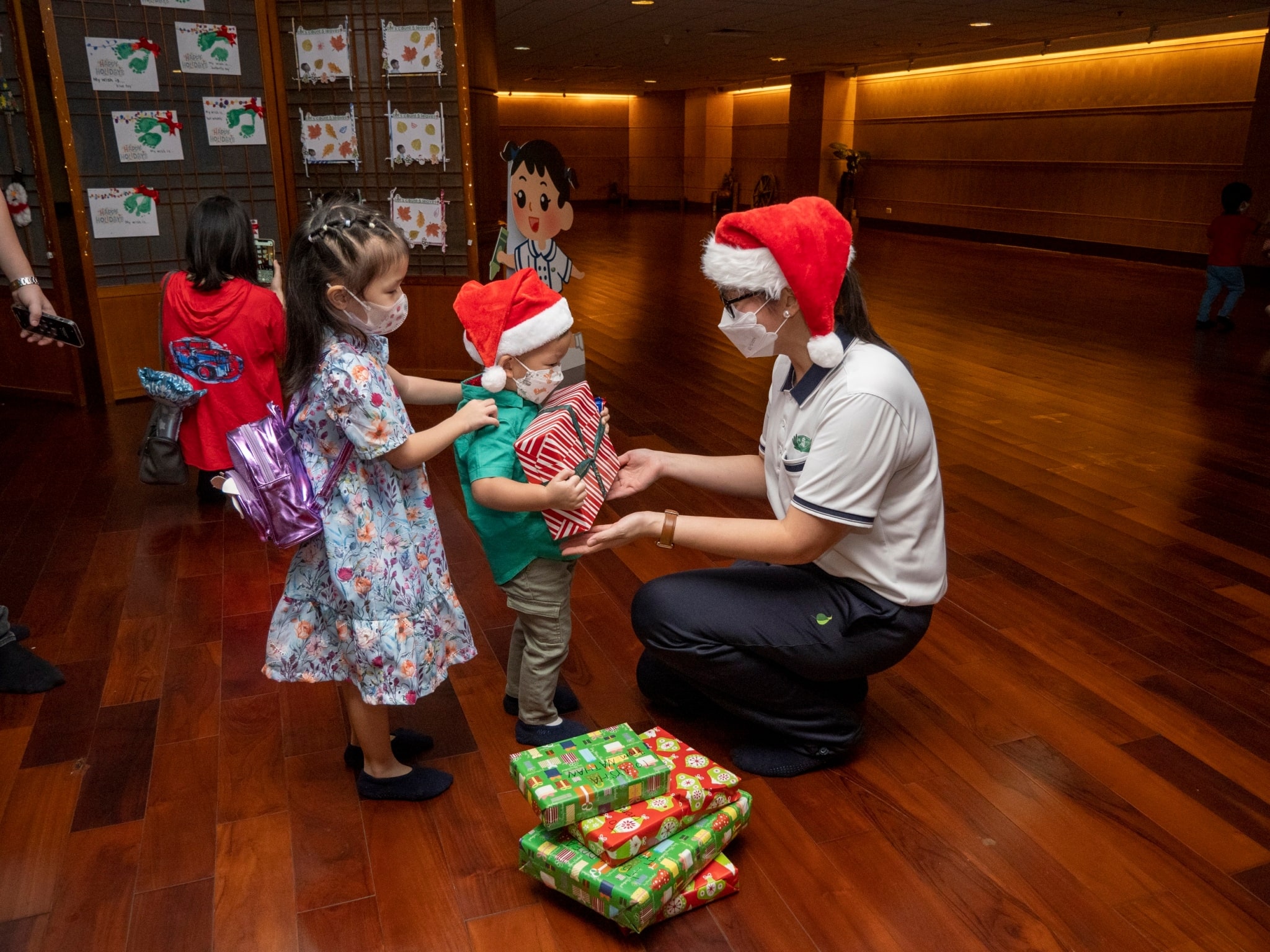 Tzu Chi Great Love Preschool Directress Jane Sy hands gift over to a student.【Photo by Harold Alzaga】