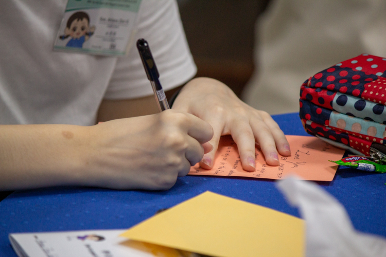 Participants write a letter to their parents after the session on filial piety. 【Photo by Marella Saldonido】