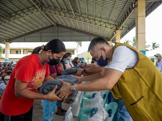 Dingalan Mayor Shierwin Taay (right) joins Tzu Chi volunteers in the distribution of goods. 【Photo by Jeaneal Dando】